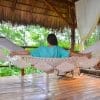 hamac à barre du Nicaragua en coton L, écru vu de fasse avec une femme assise de dos